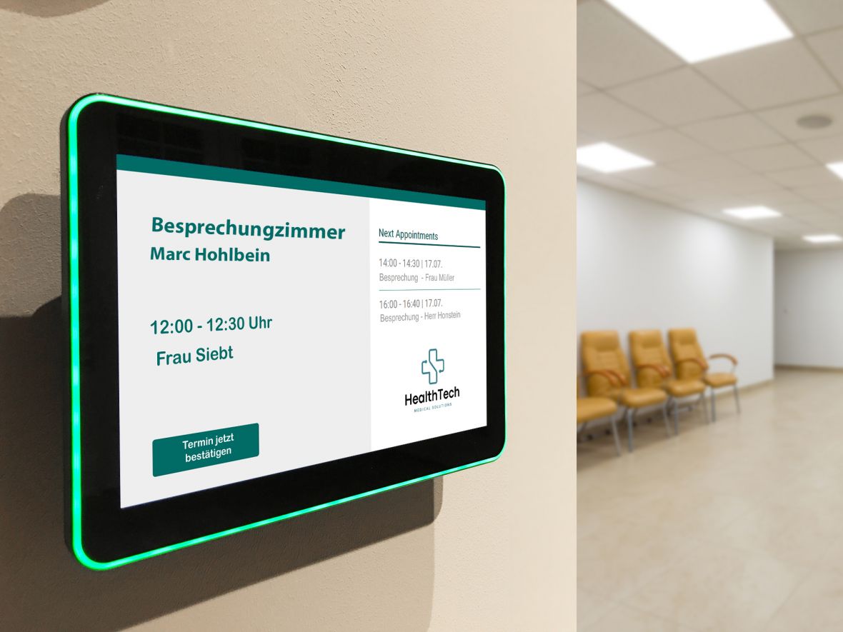 Grün leuchtendes digitales Türschild vor Besprechungszimmer